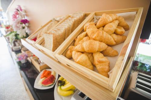 a display of bread and pastries in wooden baskets at Chada Mantra Hotel in Chiang Mai
