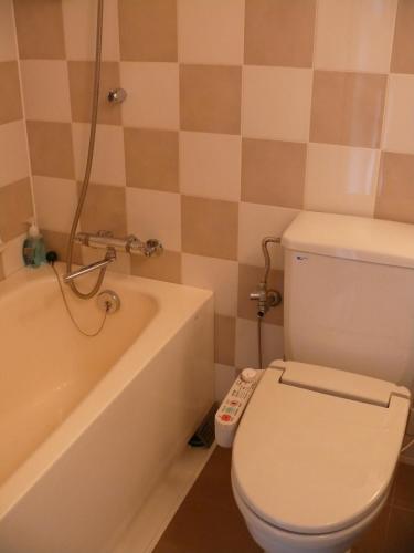 a bathroom with a toilet and a bath tub at Shibuya Excel Hotel Tokyu in Tokyo