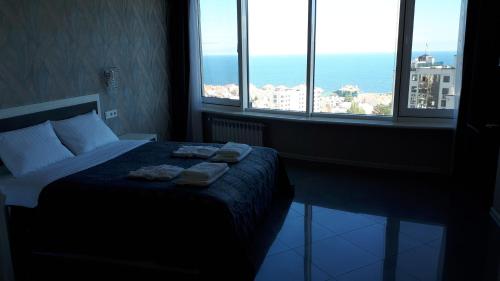 a bedroom with a bed with two towels on it at IRIS apartments in Odesa