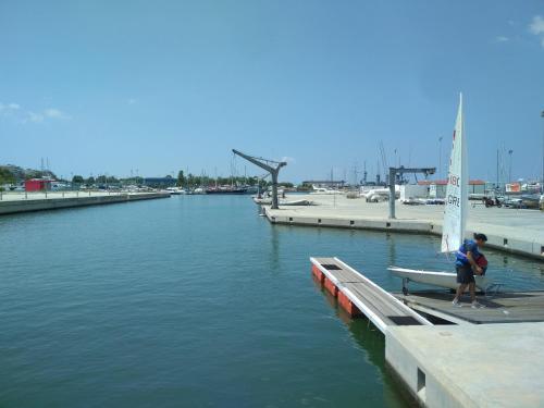 a man standing on a dock with a sail boat at George's Apartment in Athens
