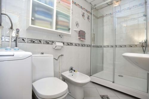 a bathroom with a toilet and a shower and a sink at Comfort Inn Old Town in Budva
