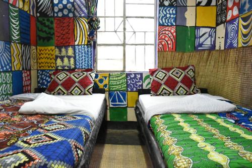 Ένα ή περισσότερα κρεβάτια σε δωμάτιο στο Red Rocks Rwanda - Campsite & Guesthouse