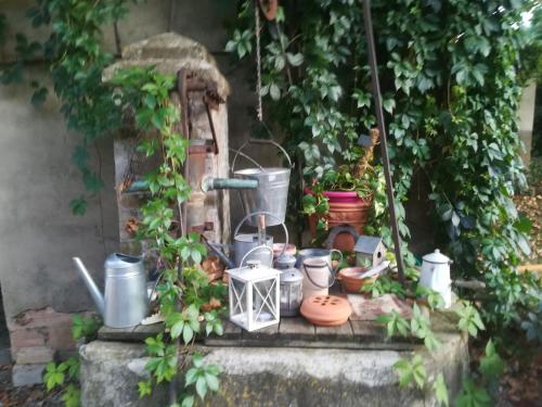 a bunch of pots and pans sitting on a ledge at Rêve d’Emma in Plan-dʼOrgon