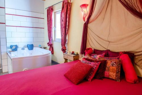 a bedroom with a bed and a tub and a bed with pillows at Hütte zum Verlieben in Gurk