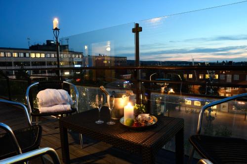 a table with candles on top of a balcony at Best Western Malmia Hotel in Skellefteå