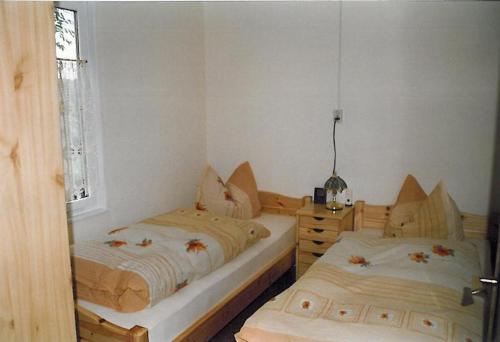 a bedroom with two beds and a window at Ferienhaus "Eierkuchen" in Lindig
