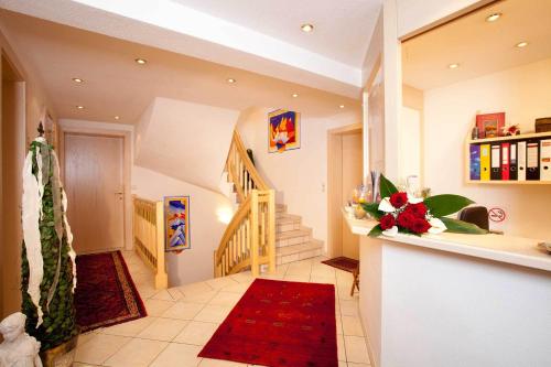 a living room with a staircase and a red rug at Ferienresidenz La Vita in Längenfeld