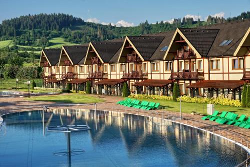 a resort with a swimming pool and a building at Apartmán Bešeňová in Bešeňová