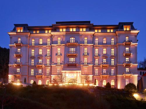 a large building with lights in front of it at Hapimag Ferienwohnungen Bad Gastein in Bad Gastein
