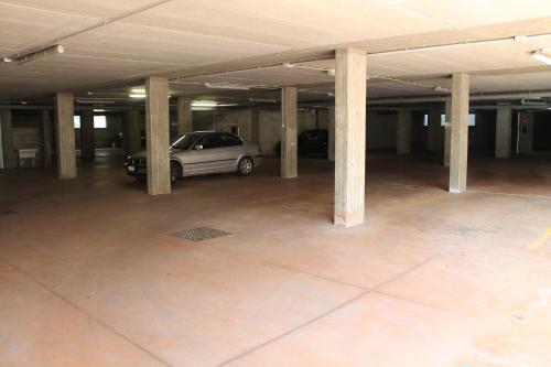 a parking garage with a car parked in it at Hotel Residence Aurora in Paderno Dugnano