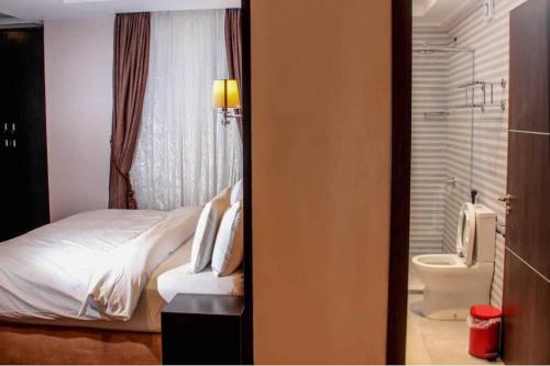 Un pat sau paturi într-o cameră la Joshesther Olive Hotel