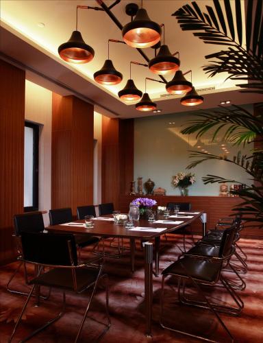 a conference room with tables and chairs and lights at Grand Noble Hotel Xi’an in Xi'an