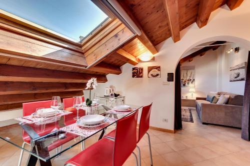a dining room with a glass table and red chairs at Cannaregio - Venice Style Apartments in Venice