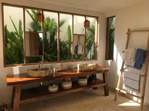 two sinks on a wooden table in a bathroom at Balian Prana in Selemadeg