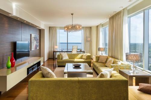 a living room with two couches and a television at Swissotel Tallinn in Tallinn