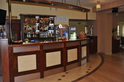 a bar in a room with a lot of alcohol at Noclegi Nad Osławą in Zagórz