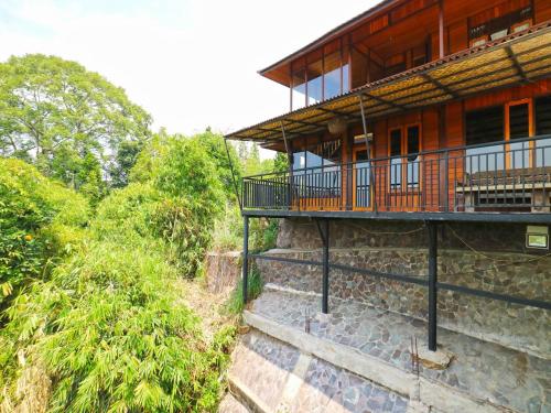a building with a balcony on the side of it at Villa Gardenia Bandung in Lembang