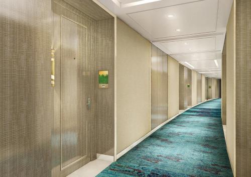 a corridor of an office building with a carpeted hallway at InterContinental Hotels Jakarta Pondok Indah by IHG in Jakarta