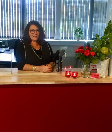 a woman sitting at a counter with candles at Motel Skive in Skive