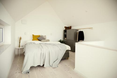 a bedroom with a bed with a blanket on it at Villa Azure I in Fehmarn