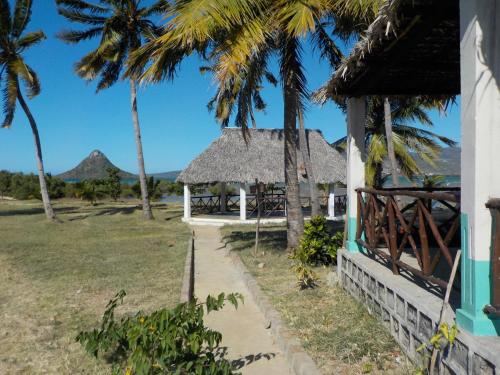 a house on the beach with palm trees at SANJEELA-PLAGE COCO in Diego Suarez