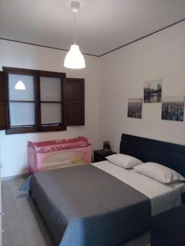 a bedroom with two beds and a pendant light at Il Cortiletto in Castelbuono