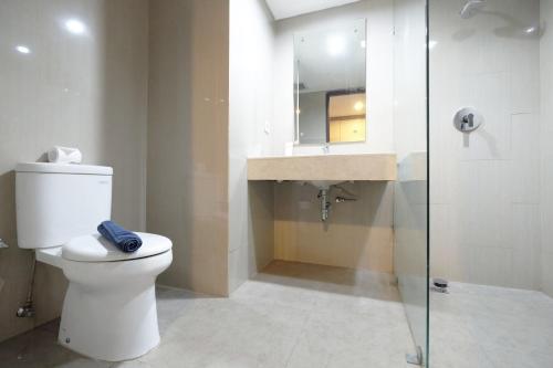 a bathroom with a toilet and a sink at Best Price Modern Studio Apartment H Residence near MT Haryono By Travelio in Jakarta