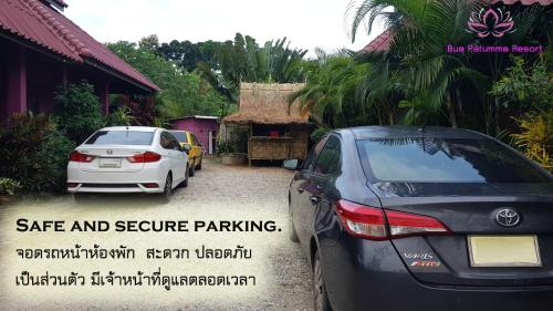 two cars parked in front of a house at Bua Patumma Resort in Mae Sai