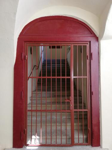 a red door with a gate in a building at Ferdinand Apartments in Mediaş