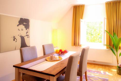 a dining room with a wooden table and chairs at Villa Leopoldskron in Salzburg