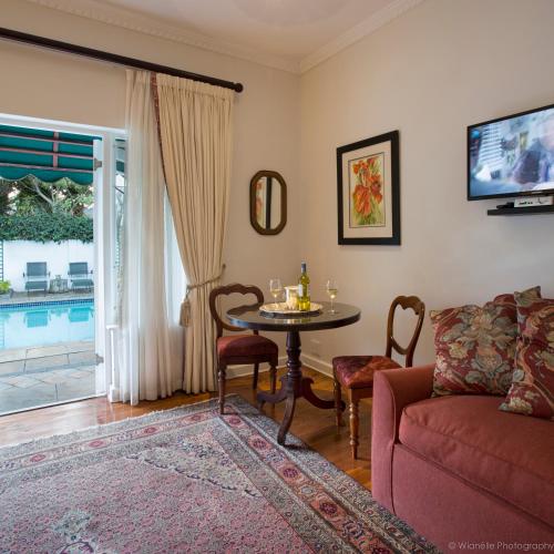 a living room with a table and a couch at Carslogie House in Port Elizabeth