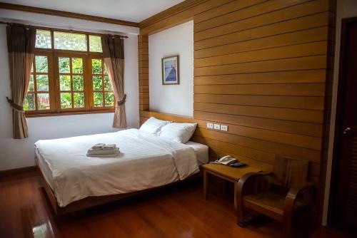 a bedroom with a bed and a window at Tree Home Plus in Nakhon Si Thammarat