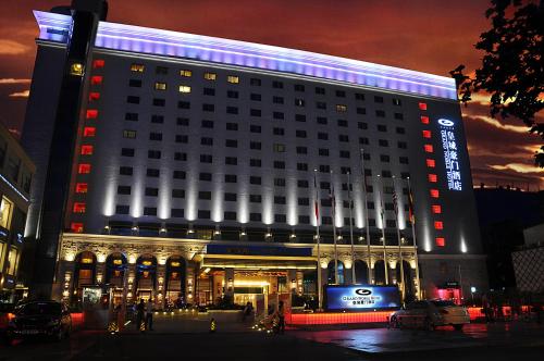 a large building with a sign on it at night at Grand Noble Hotel Xi’an in Xi'an