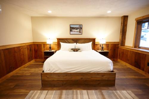 a bedroom with a large bed with two night stands at Seesaw's Lodge in Peru