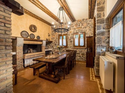 a dining room with a table and a brick wall at Villa Mylonas in Áno Polídhrosos