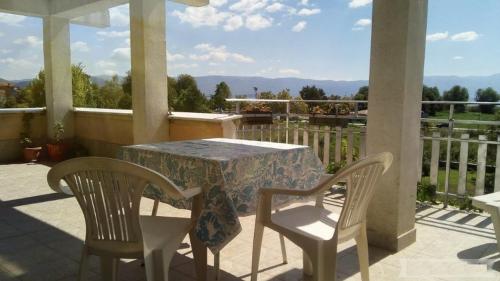 a table and two chairs on a porch with a view at Marko Apartments in Struga