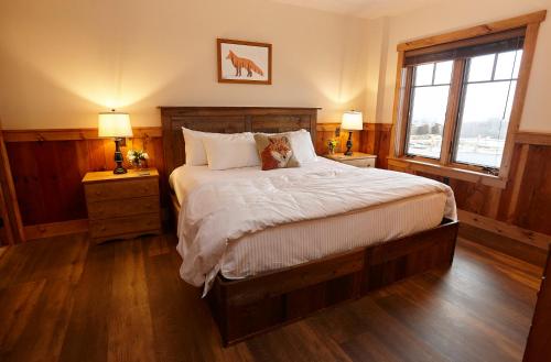 a bedroom with a bed with two night stands and a window at Seesaw's Lodge in Peru