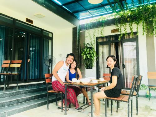 a group of people sitting at a table at Coto Center Homestay in Dao Co To