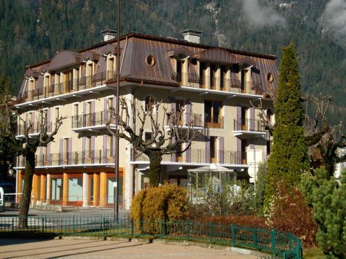 
a large building with a clock on the top of it at Quartz-Montblanc in Chamonix
