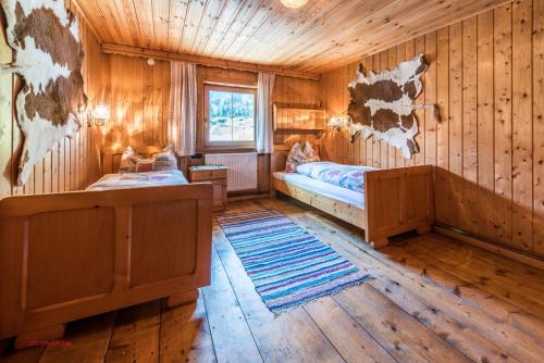 a room with two beds in a log cabin at Almliesl RAUR-437 in Rauris