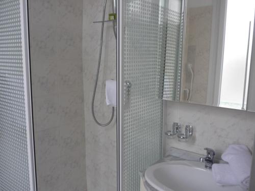 a bathroom with a shower and a sink at Logis Hôtel Villa Victorine in Nice