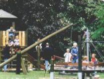 um grupo de pessoas andando em torno de um playground em Gästehaus Hankhausen em Rastede