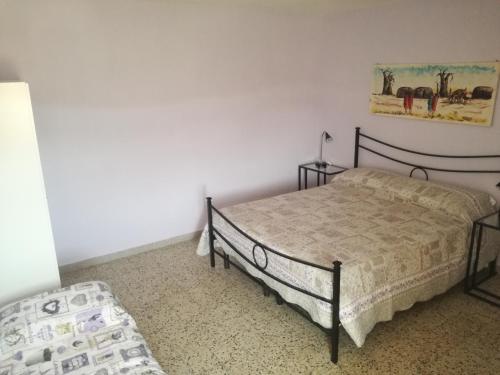a bedroom with two beds in a room with white walls at B&B La Rondinella in Montecerboli