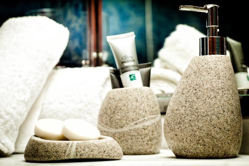 a bathroom counter with a sink with a faucet at Hotel Panorama in Thessaloniki