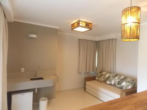 a living room with a couch and a chandelier at Resort da Ilha in Sales