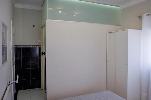 a bathroom with a shower and a glass door at Maiahouse in Maia