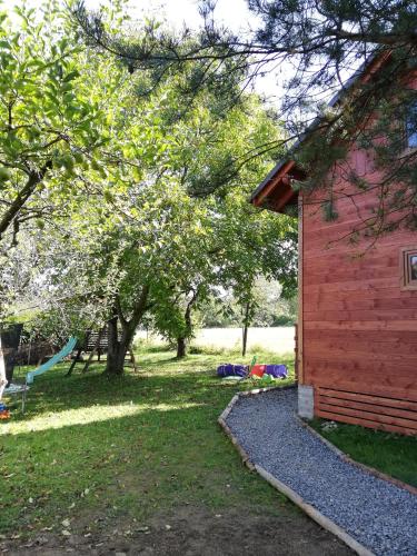 a red building with a playground in a park at Wiejska Sielanka noclegi Ustroń in Ustroń