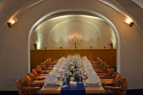 a long table in a large room with chairs at SORAT Hotel Cottbus in Cottbus