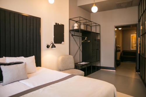 a bedroom with a bed and a chair in a room at Hotel Rum Budapest in Budapest