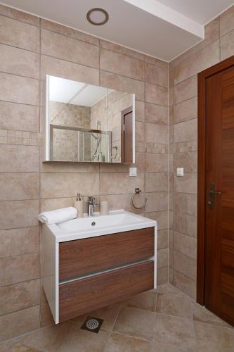 a bathroom with a sink and a mirror at Villa Lurda Linardici Krk in Linardići